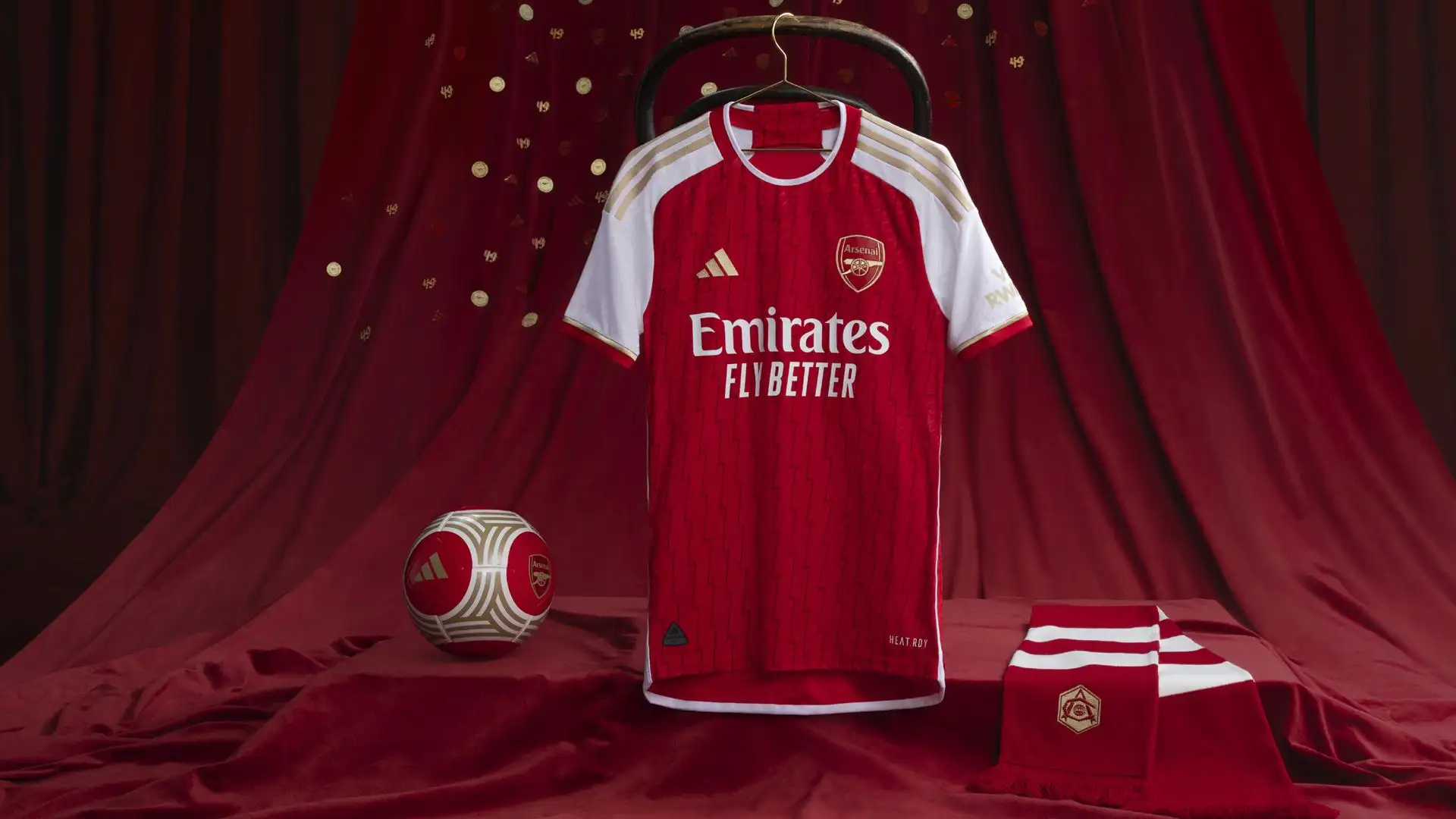 Lo stemma dell'Arsenal, il logo dell'azienda e le tre strisce lungo ogni manica sono tutti in oro