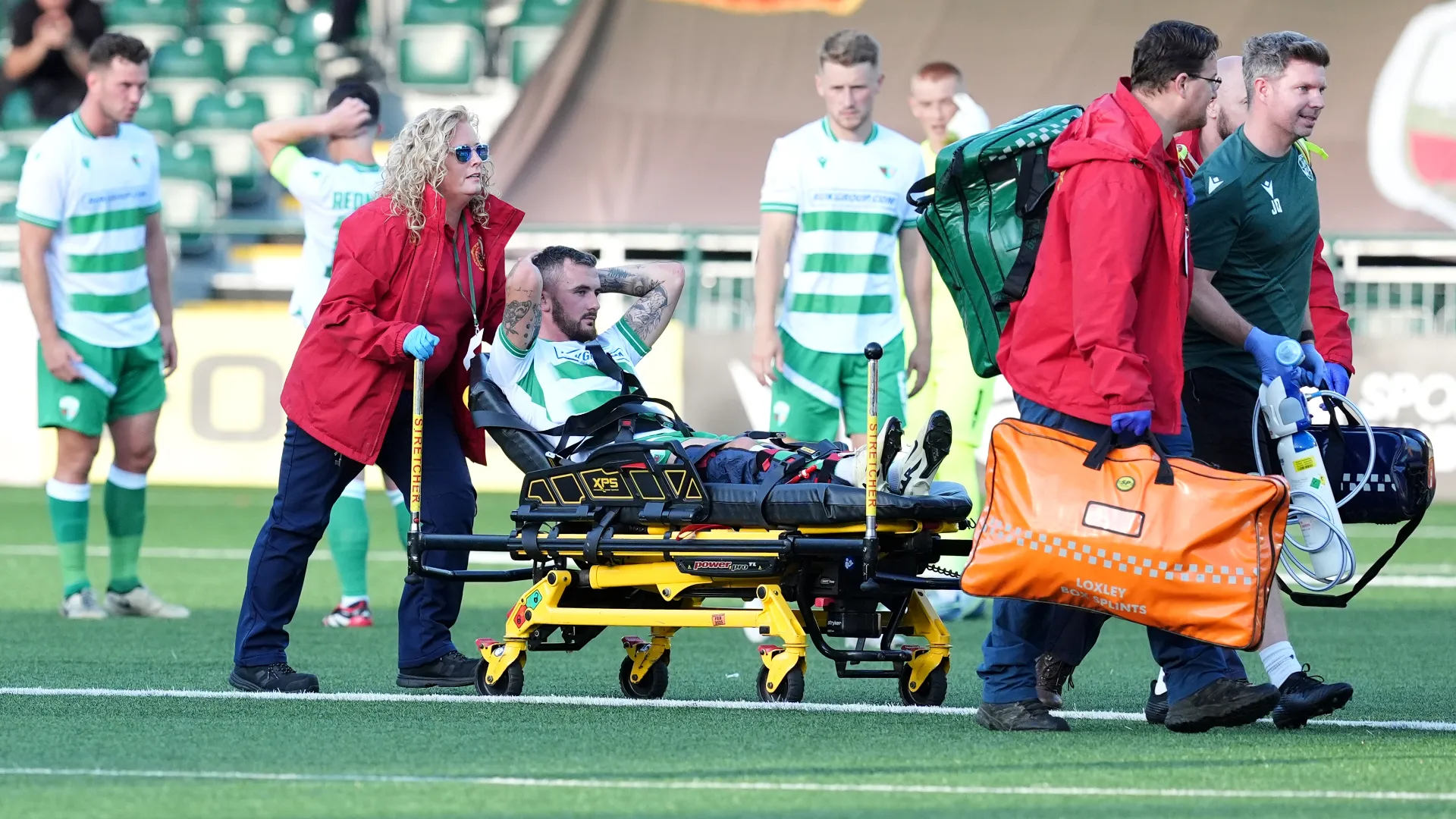 I dottori l'hanno caricato sulla barella e l'hanno portato fuori dal campo
